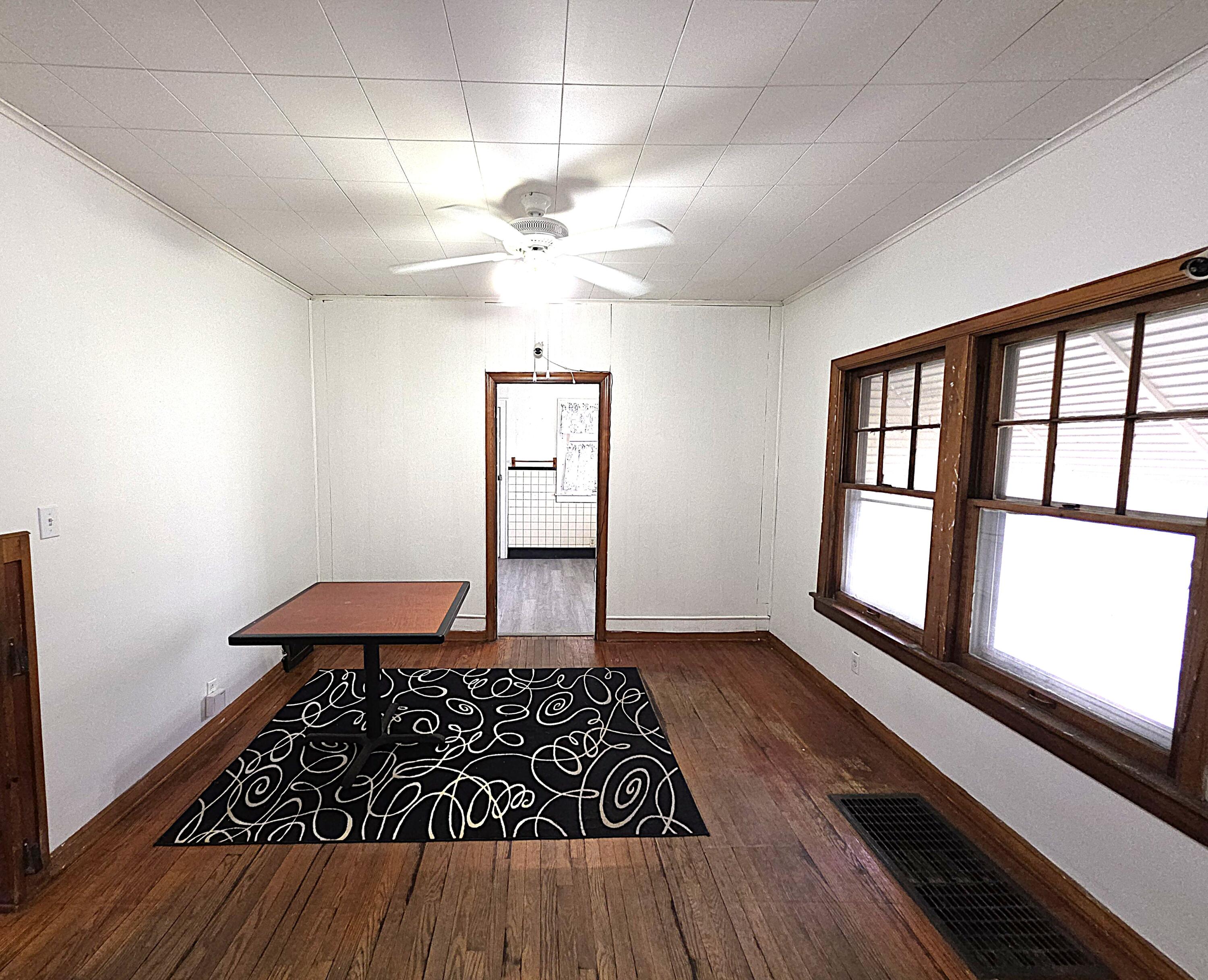 1173 Tyler Street Gary, IN 46407 - Photo 9 of 36 wooden floor in an empty room with a window