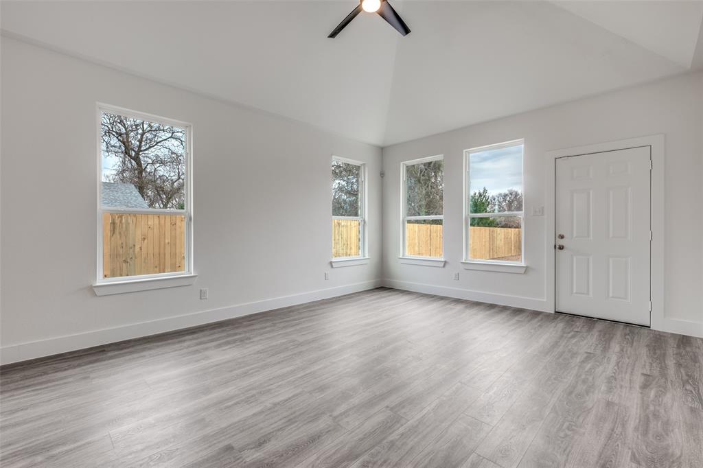 4812 Fellows Lane Dallas, TX 75216 - Photo 6 of 25 a view of an empty room with a window and wooden floor