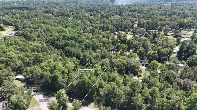 an aerial view of residential house with outdoor space and trees