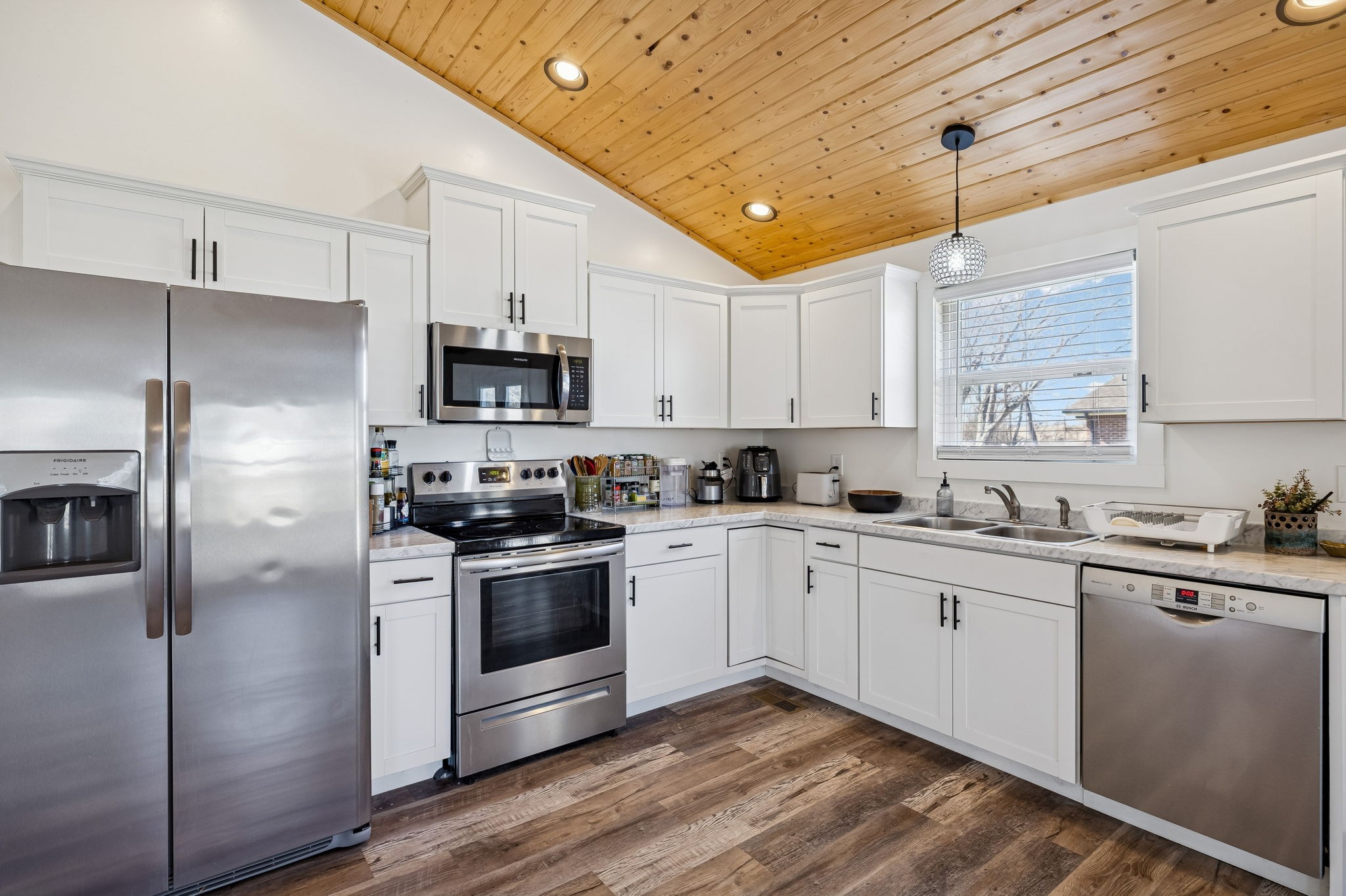 516 Davis Street Cowan, TN 37318 - Photo 13 of 40 a kitchen with stainless steel appliances granite countertop a stove a sink and a refrigerator