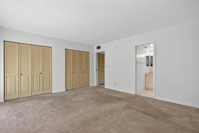 a bathroom with a sink a toilet a mirror a vanity and shower
