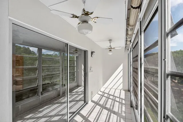 a city street lined with parked cars and a buildings