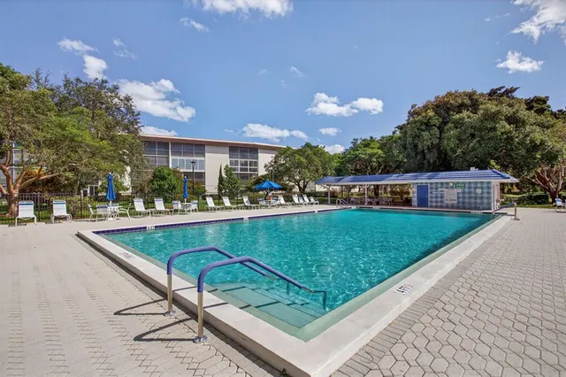 a view of a house with swimming pool and sitting area