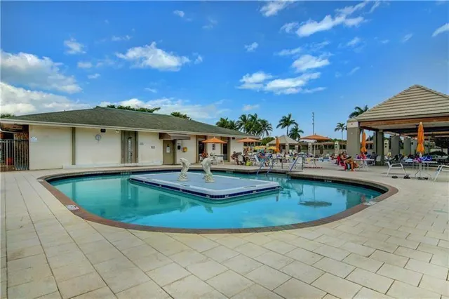 a view of a house with swimming pool and sitting area