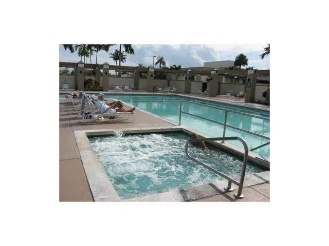 a open kitchen with stainless steel appliances granite countertop a stove top oven table and chairs