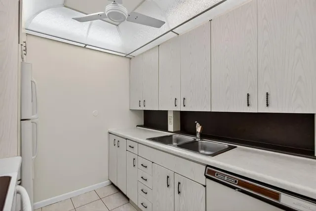 a bathroom with a granite countertop sink toilet a mirror and shower