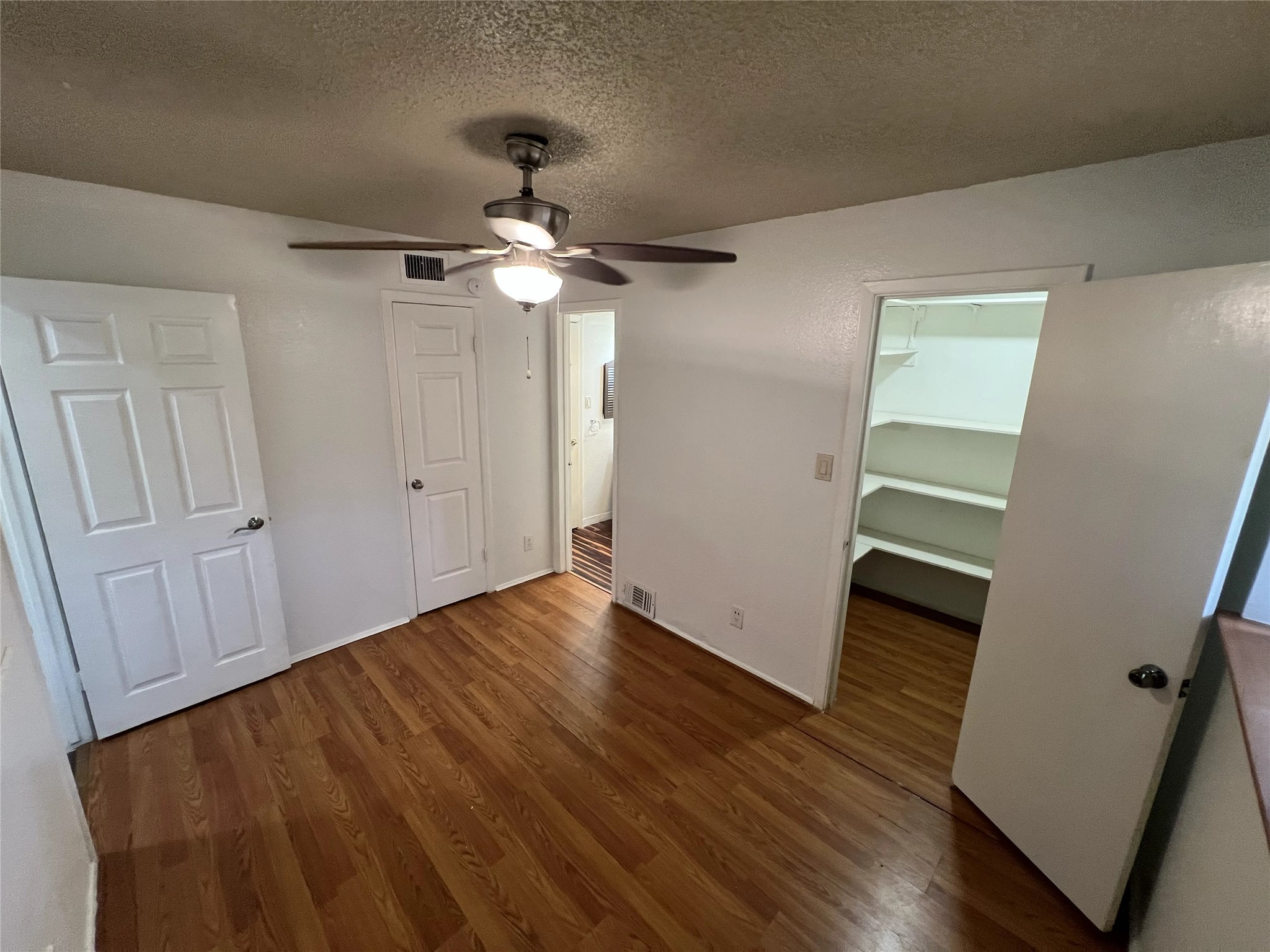 2500 Burleson Road, Unit 622 Austin, TX 78741 - Photo 7 of 17 A well-lit bedroom features hardwood floors and a convenient walk-in closet.