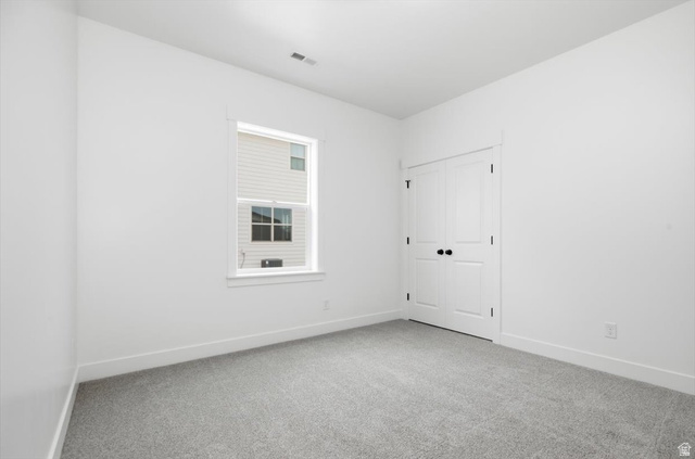 164 North 400 East Preston, ID 83263 - Photo 14 of 21 Light gray carpeted room with white walls, a single window, and white bi-fold doors with black hardware