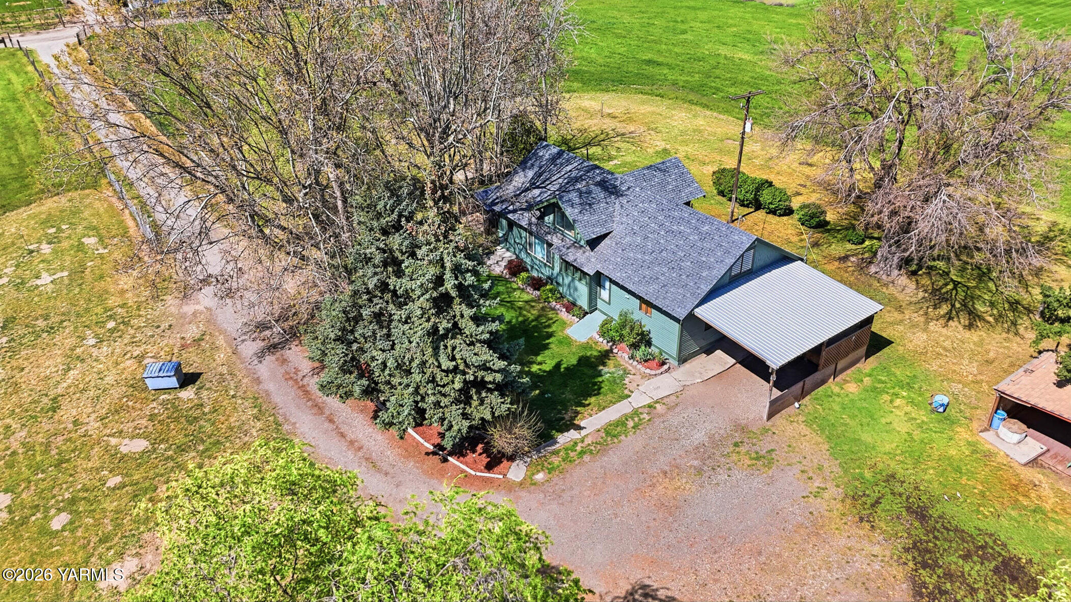 721 Blaine Road Granger, WA 98932 - Photo 37 of 45 a view of a house with a yard and garden