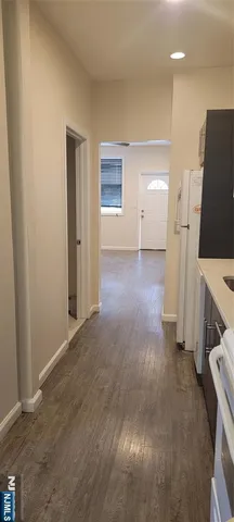 an empty room with a fireplace and wooden floor