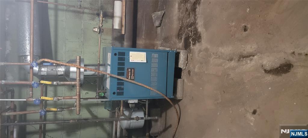 196 Fort Lee Road Teaneck, NJ 07666 - Photo 10 of 13 a room with water heater and racks on the wall