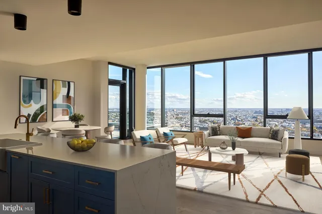 a living room with couches and a dining table with garden view