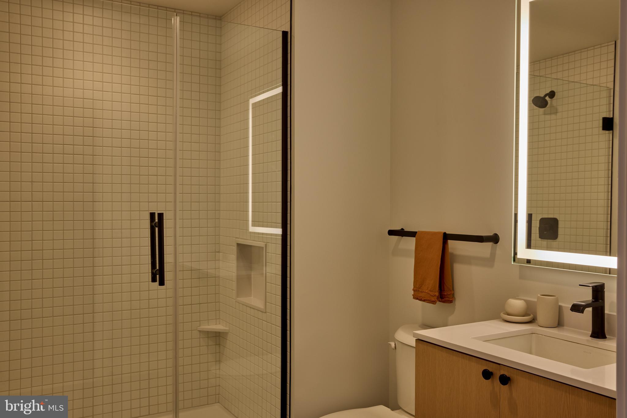 1134 Sansom Street, Unit 1B1706 Philadelphia, PA 19107 - Photo 19 of 33 a bathroom with a sink and mirror