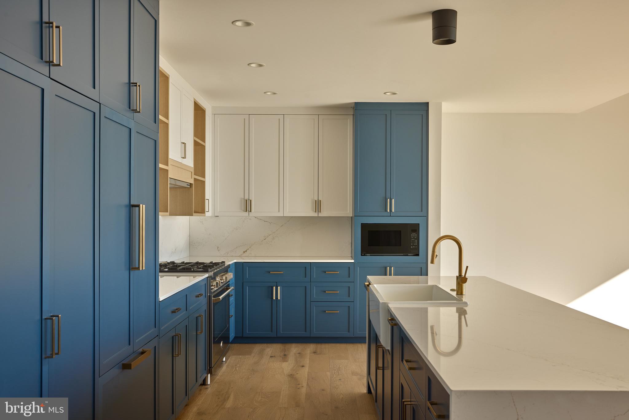 1134 Sansom Street, Unit 1B1706 Philadelphia, PA 19107 - Photo 23 of 33 a kitchen with a sink stove and cabinets