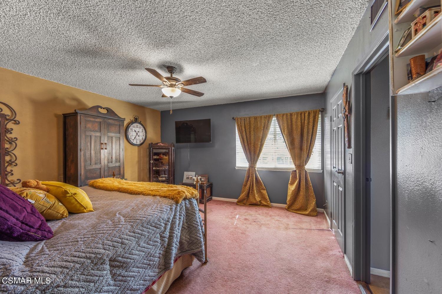725 Erringer Road Simi Valley, CA 93065 - Photo 24 of 36 a bedroom with a bed and window