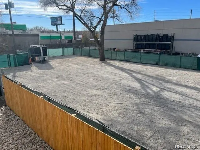 a view of backyard with wooden fence
