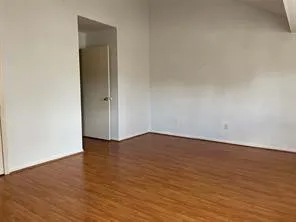 a view of an empty room and wooden floor