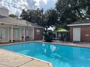 a view of a house with swimming pool and porch with furniture