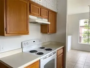 a kitchen with a sink and a stove top oven