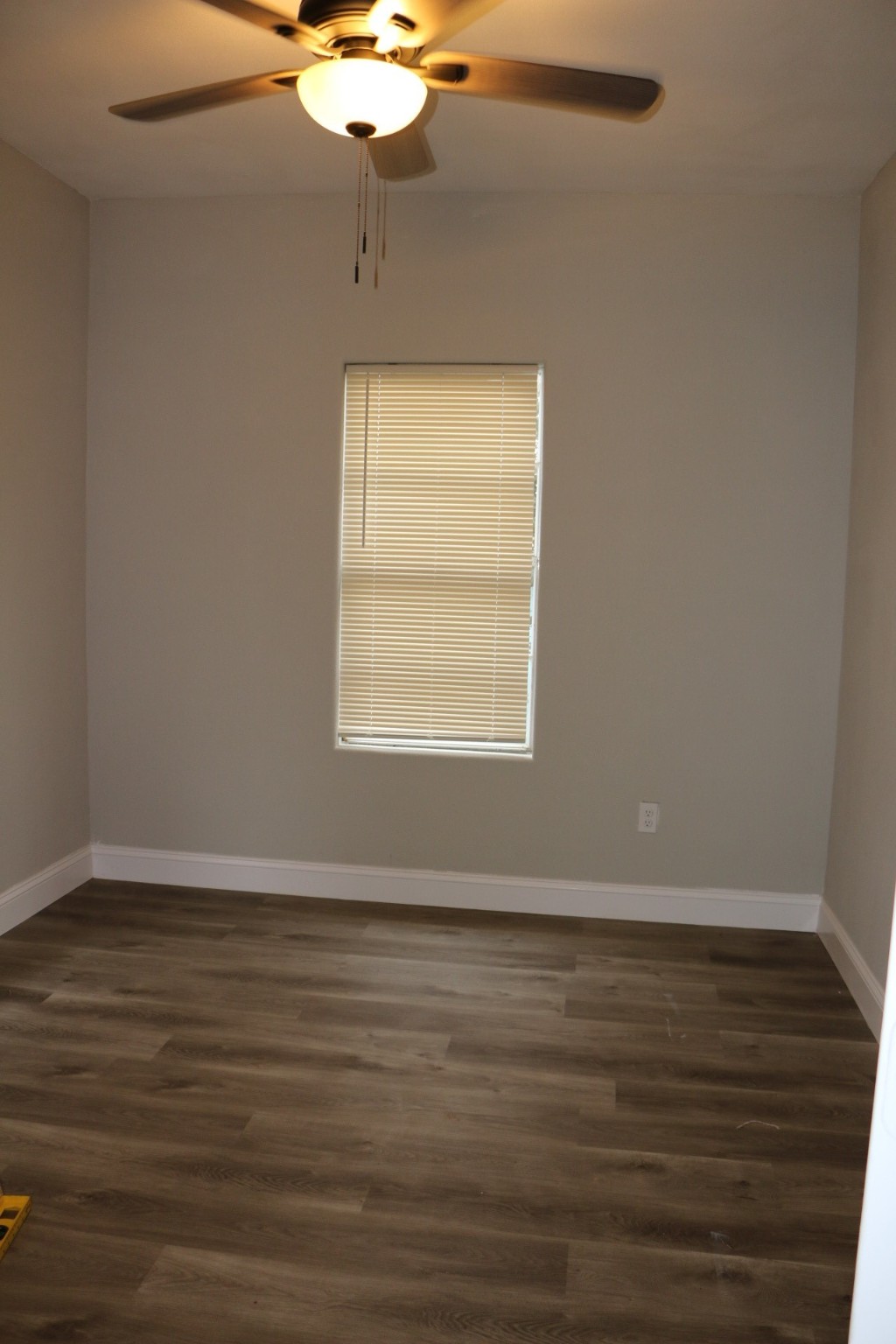 1014 West 4th Street Freeport, TX 77541 - Photo 14 of 16 a view of an empty room with wooden floor and a window