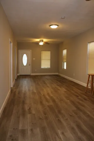 a view of a room with window and wooden floor