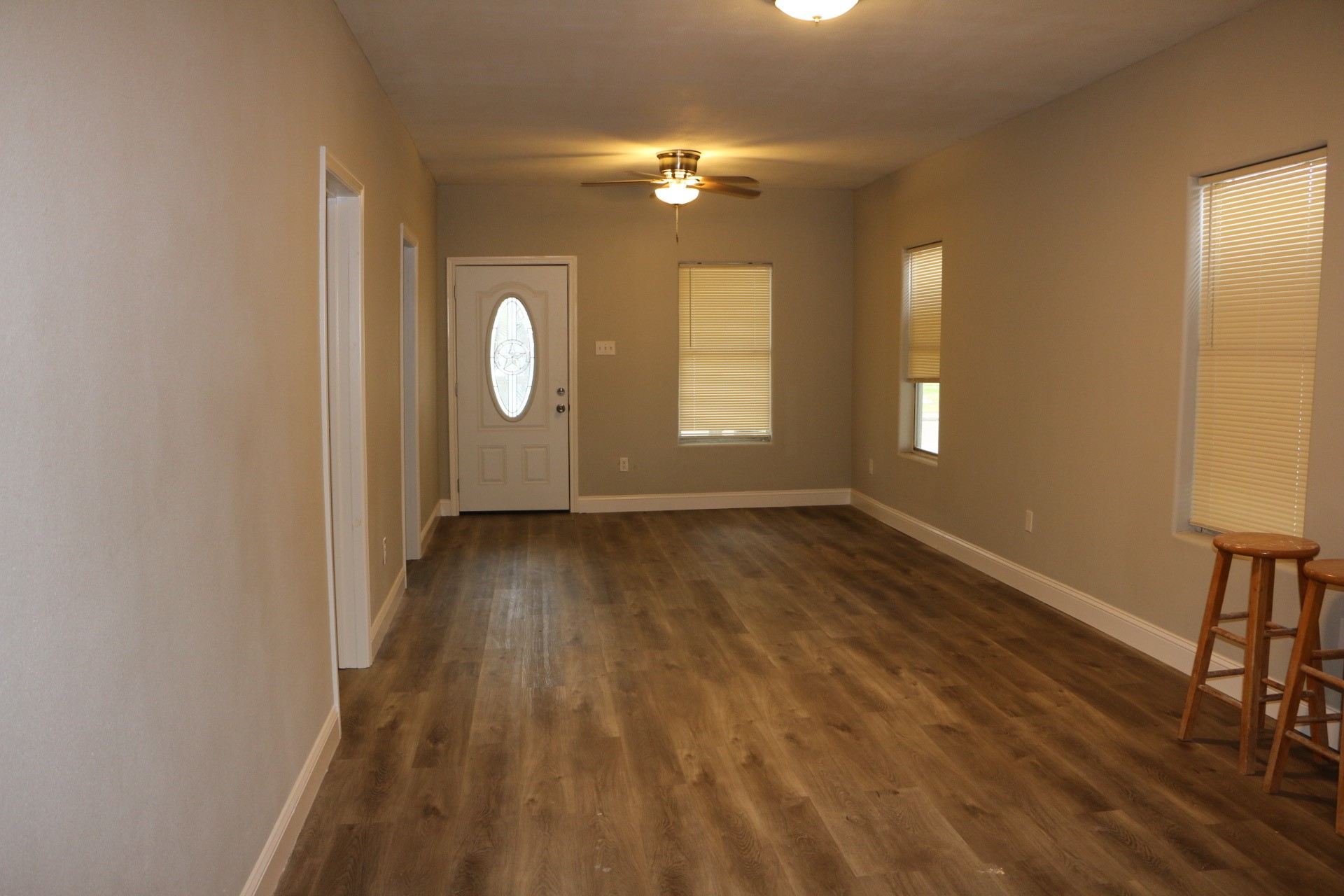1014 West 4th Street Freeport, TX 77541 - Photo 16 of 16 a view of an empty room with wooden floor and a window