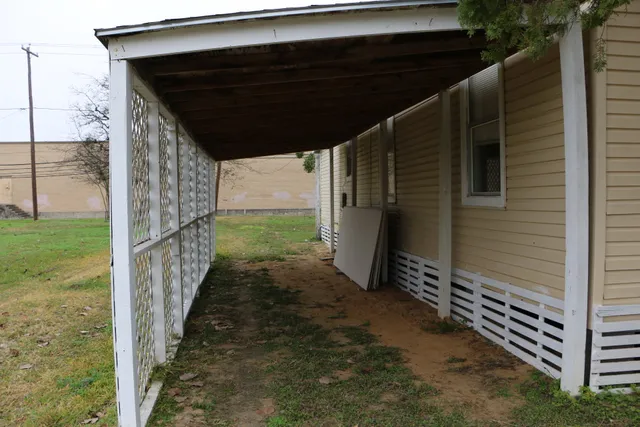 a view of a pathway of a house with backyard