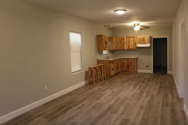 a kitchen with a sink cabinets and wooden floor
