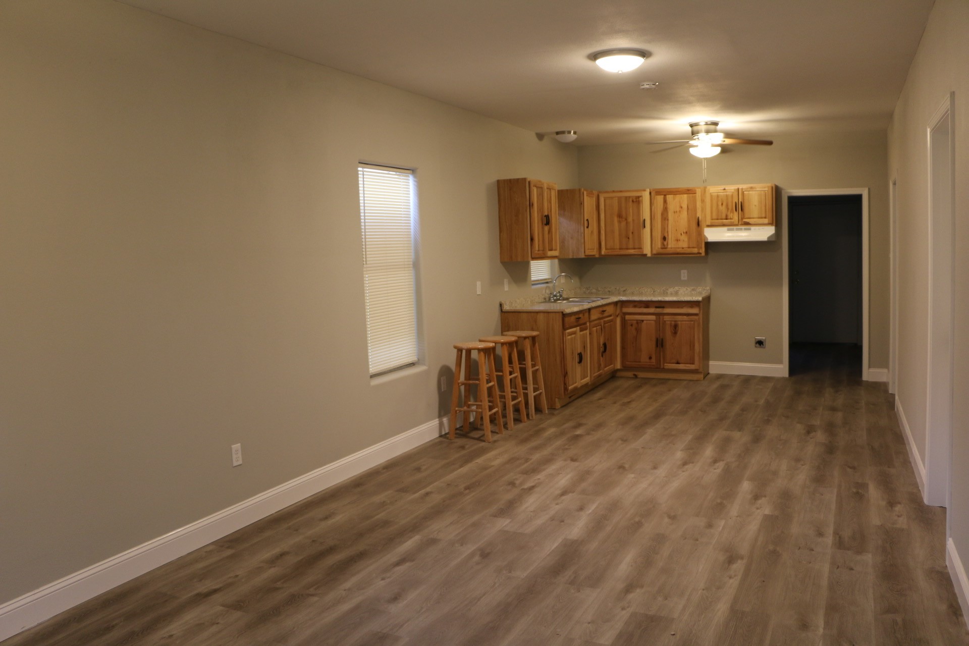1014 West 4th Street Freeport, TX 77541 - Photo 3 of 16 a kitchen with a sink cabinets and wooden floor