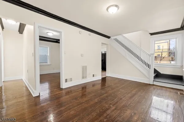 a view of an entryway with wooden floor