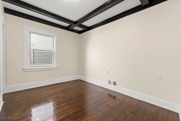 a view of a room with wooden floor and windows