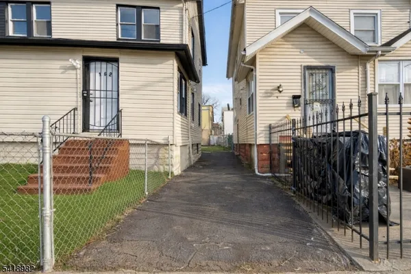 a view of a house with wooden fence