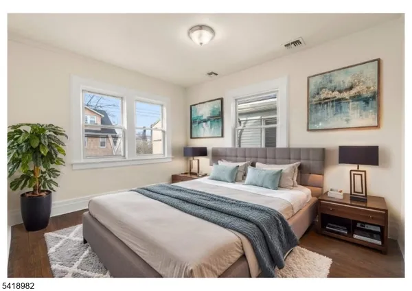 a bedroom with a bed and a large window