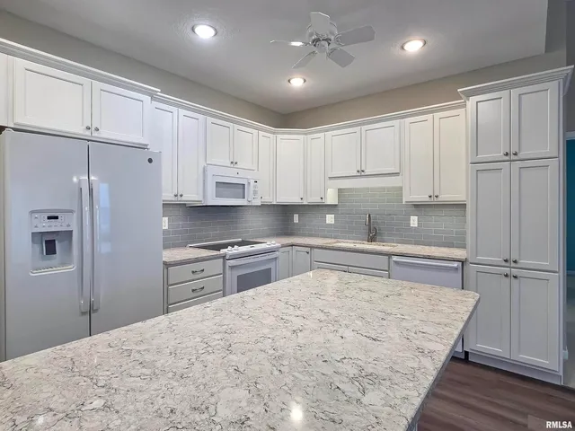 a large kitchen with cabinets and stainless steel appliances