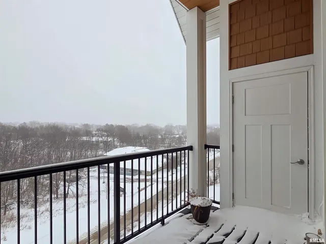 a view of a balcony with wooden floor and fence