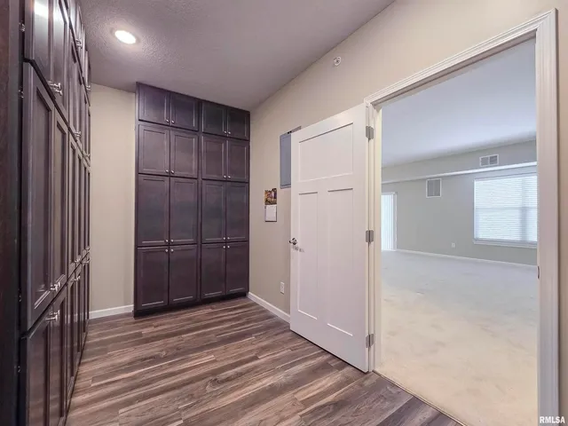 an empty room with a ceiling fan and windows