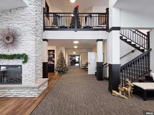 a view of a livingroom with wooden floor and furniture