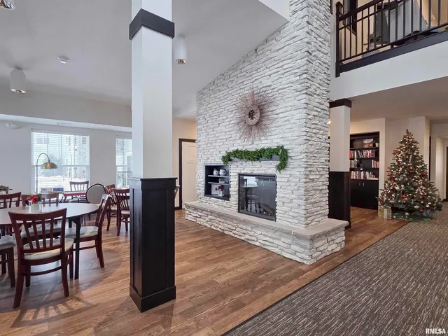 a living room with fireplace furniture and a wooden floor