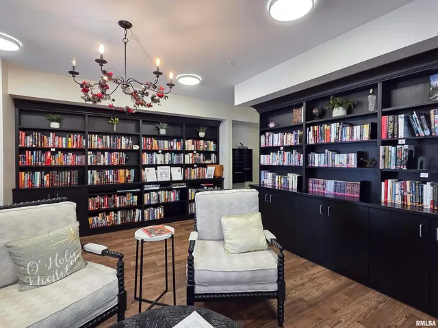 a view of living room filled with furniture and book shelf