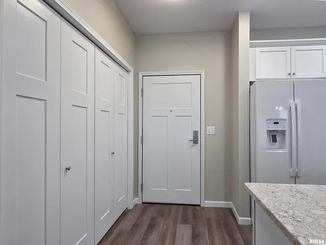 a view of hallway with wooden floor