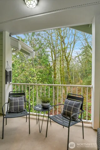 a view of a chairs and couch in the balcony