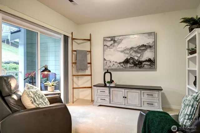 a living room with furniture and a painting on the wall