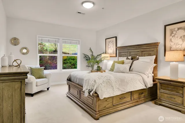 a spacious bedroom with a bed and a large window