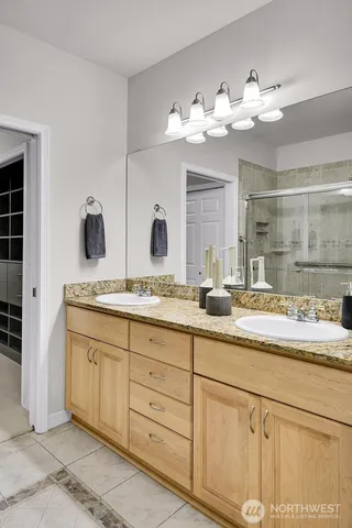 a bathroom with a sink vanity and mirror