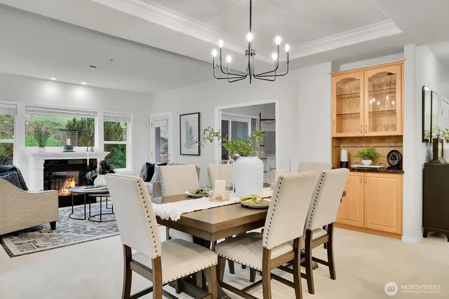 a living room with fireplace furniture and a chandelier