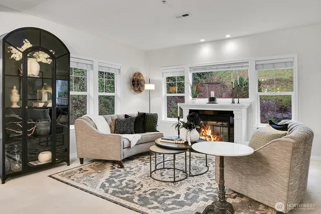 a living room with furniture a fireplace and a table