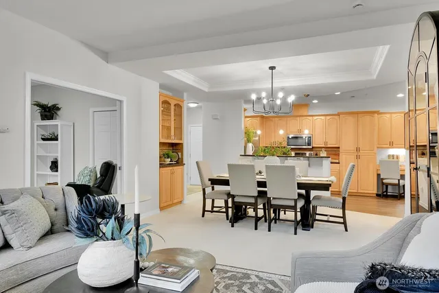 a view of a dining room with furniture and chandelier