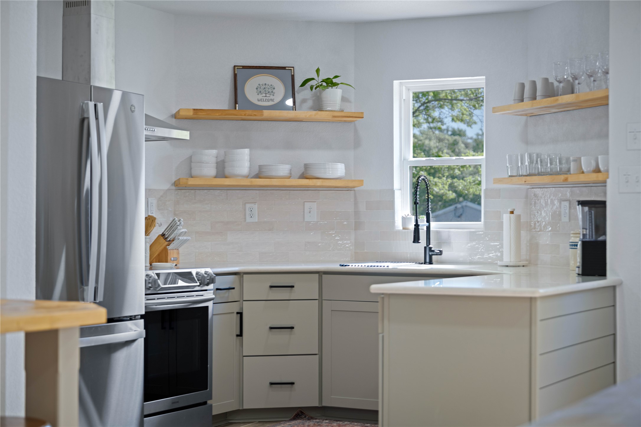 131 Campfire Circle Wimberley, TX 78676 - Photo 12 of 40 a kitchen with cabinets appliances and a window