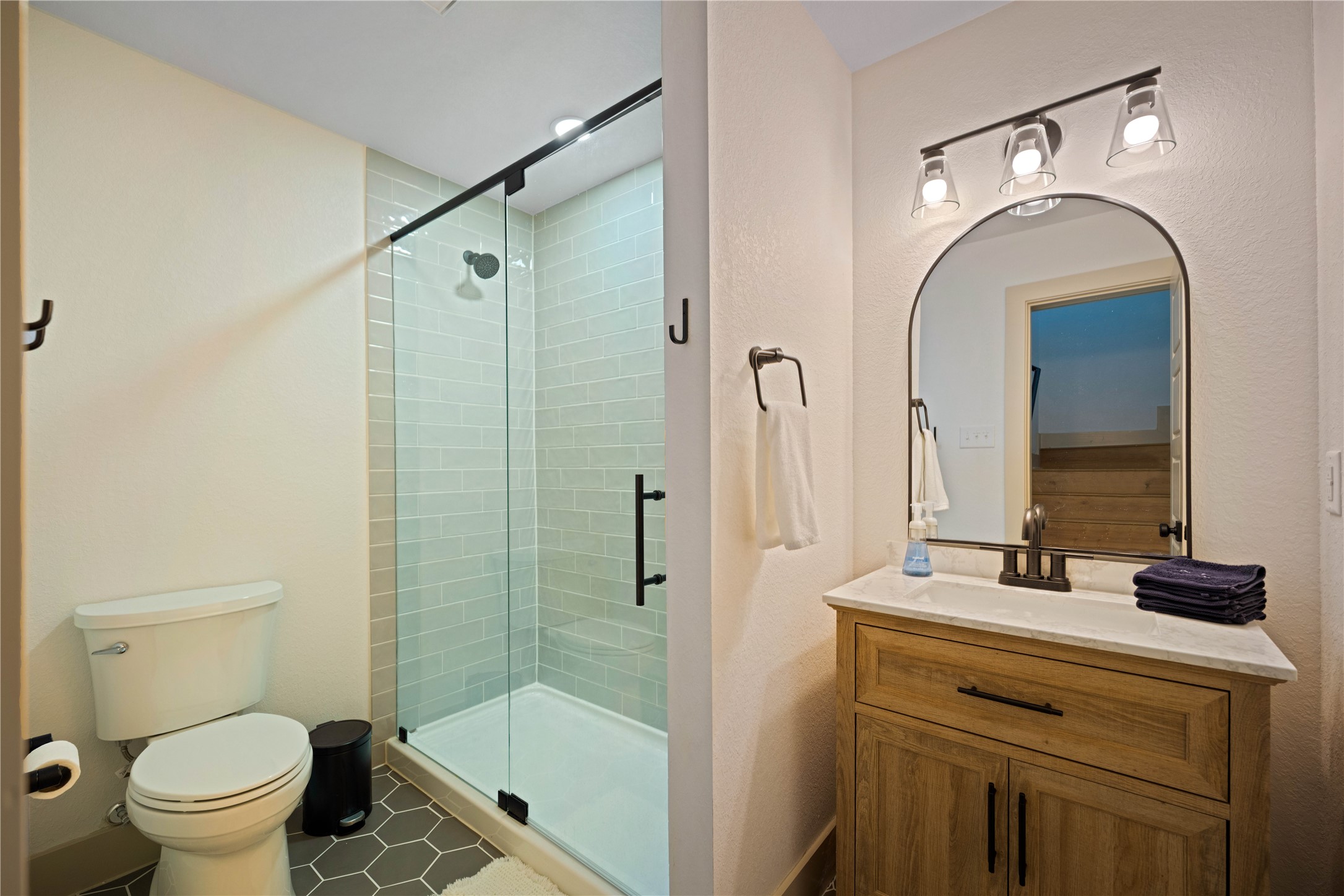 131 Campfire Circle Wimberley, TX 78676 - Photo 15 of 40 a bathroom with a granite countertop sink a toilet and a mirror