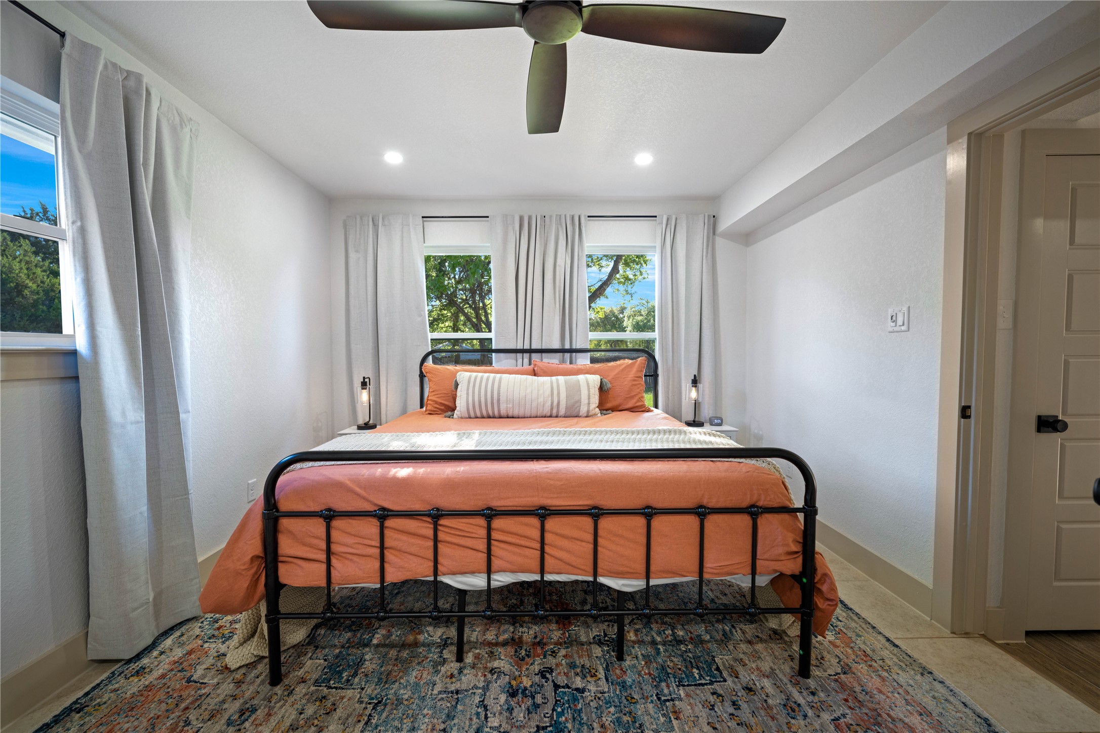 131 Campfire Circle Wimberley, TX 78676 - Photo 17 of 40 a bedroom with a bed a window and potted plant